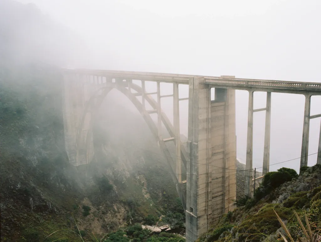 Fog surrounds a tall bridge